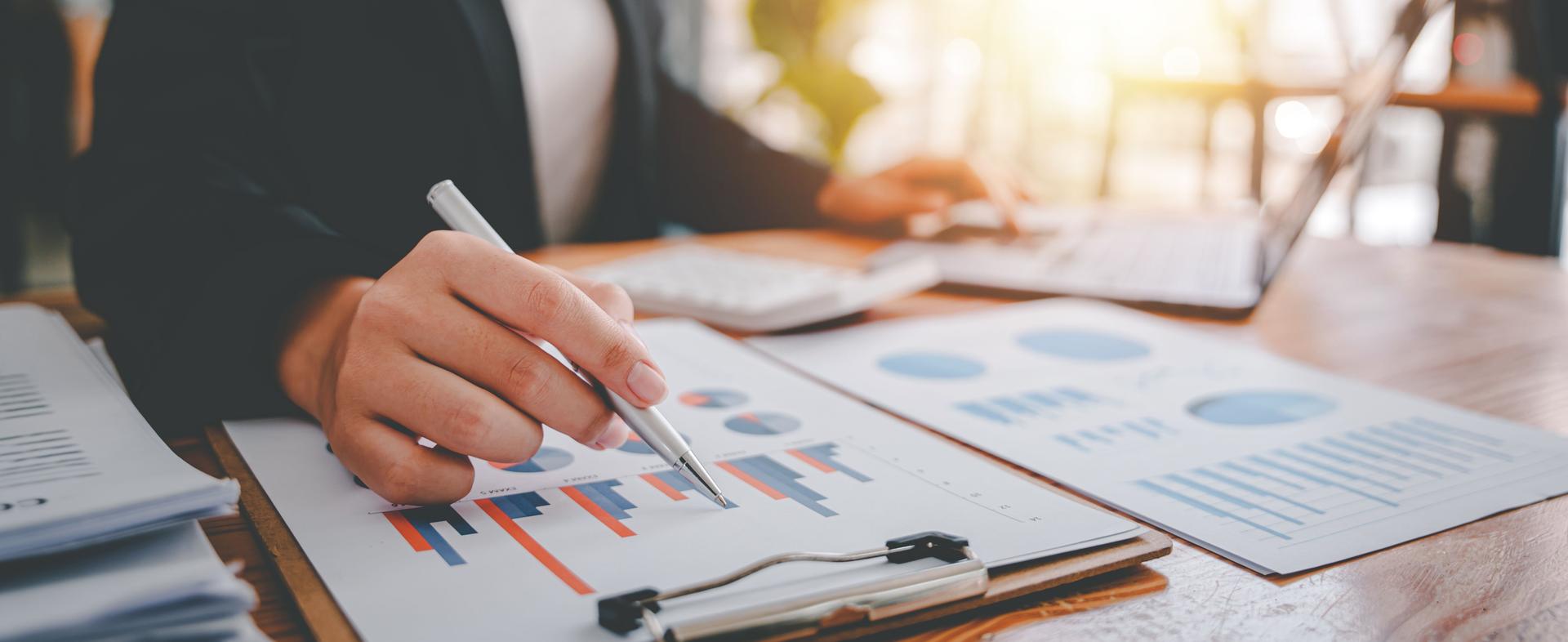 Portrait of a woman working on a tablet computer in a modern office. Make an account analysis report. real estate investment information financial and tax system concepts