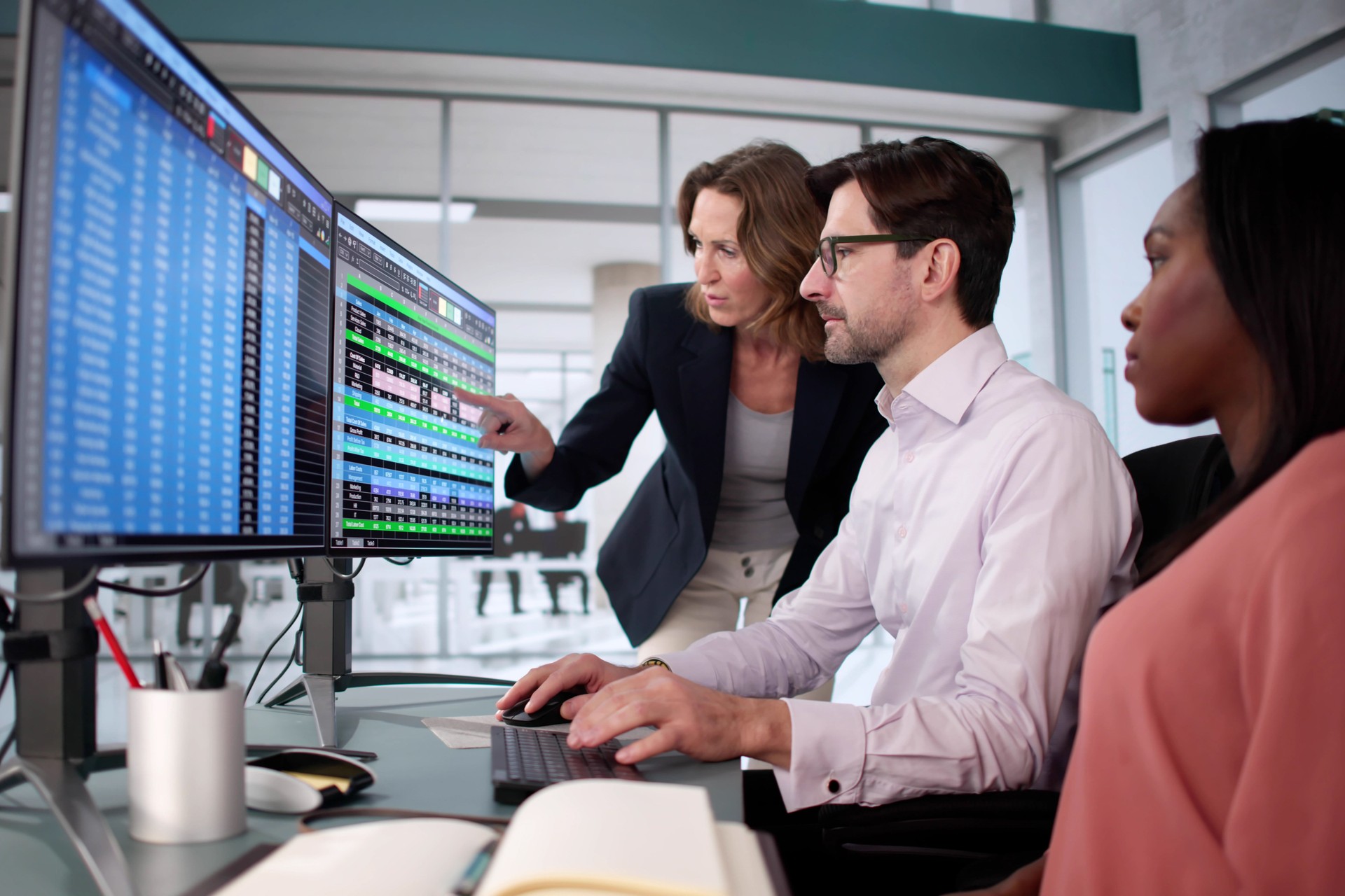 Multiracial business team using spreadsheet software