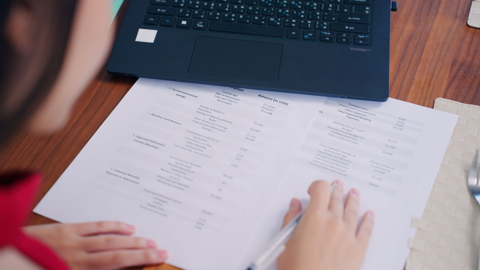 Asian financial advisor checking the details in the documents about retirement planning worksheets for her family to secure retired life, young adult woman examining the finance status before choosing retirement plans